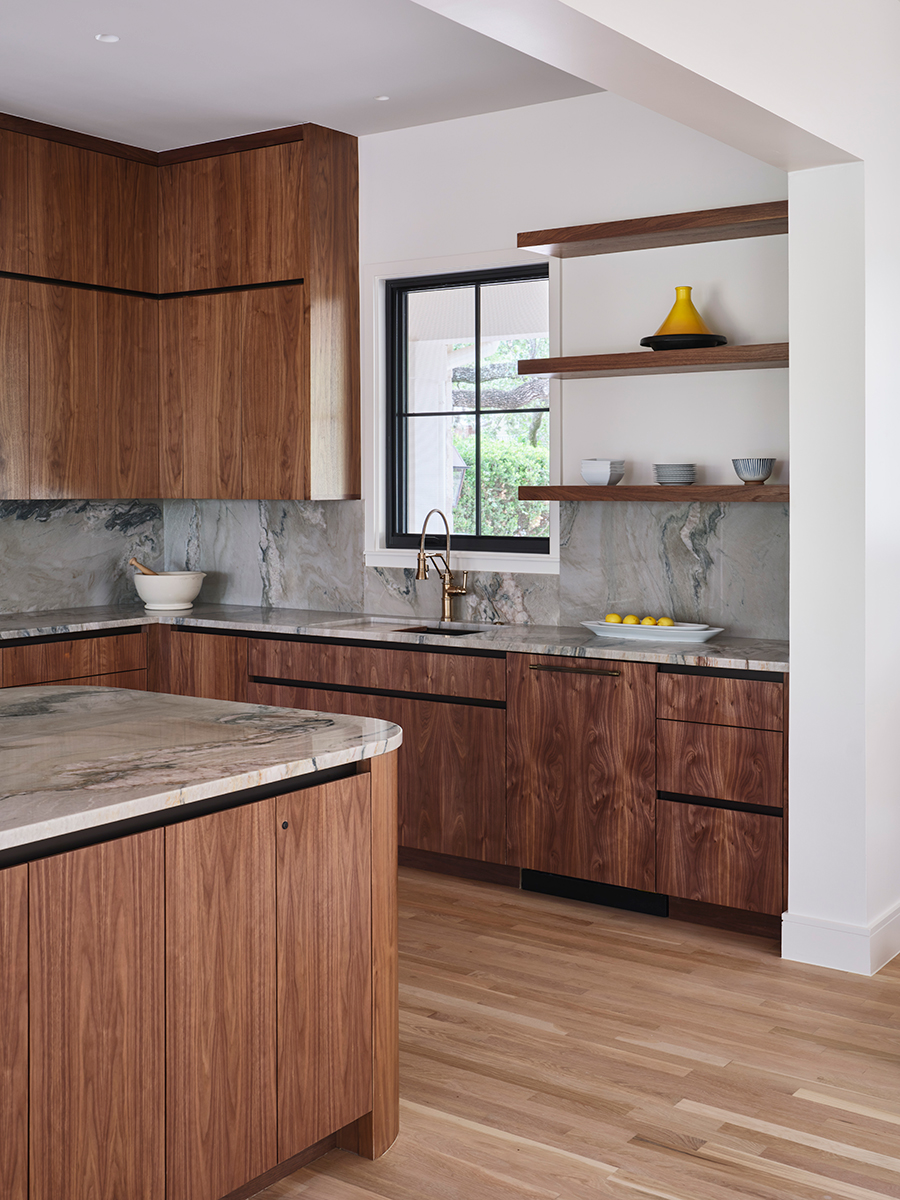 Renovated and expanded kitchen with mahogany cabinets and a dynamic-patterned stone backsplash.