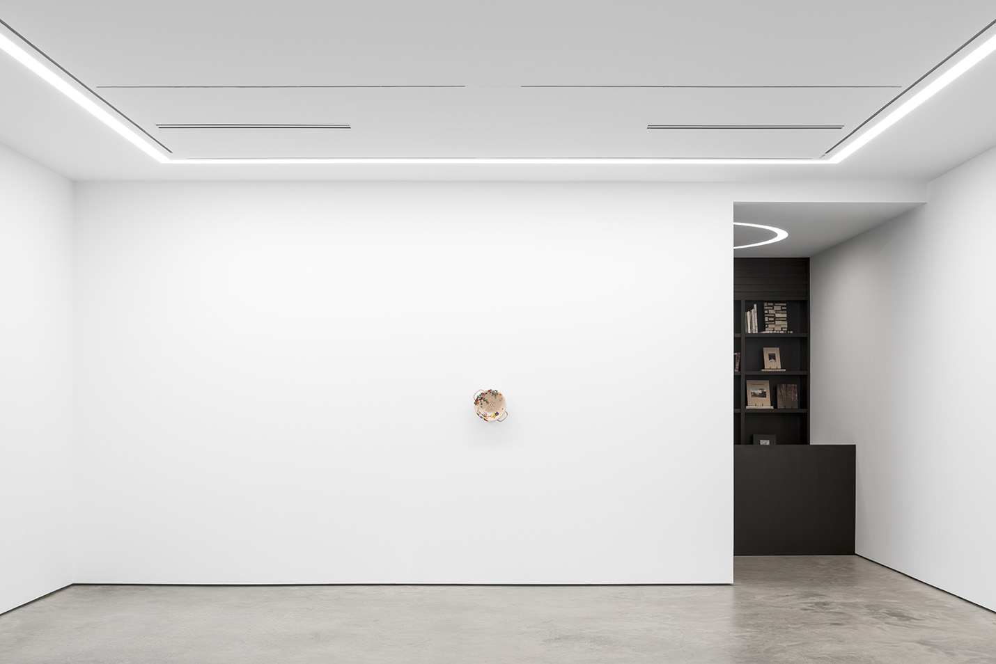 Gallery wall with library in rear of Lora Reynolds Gallery designed by Stonefox Architecture