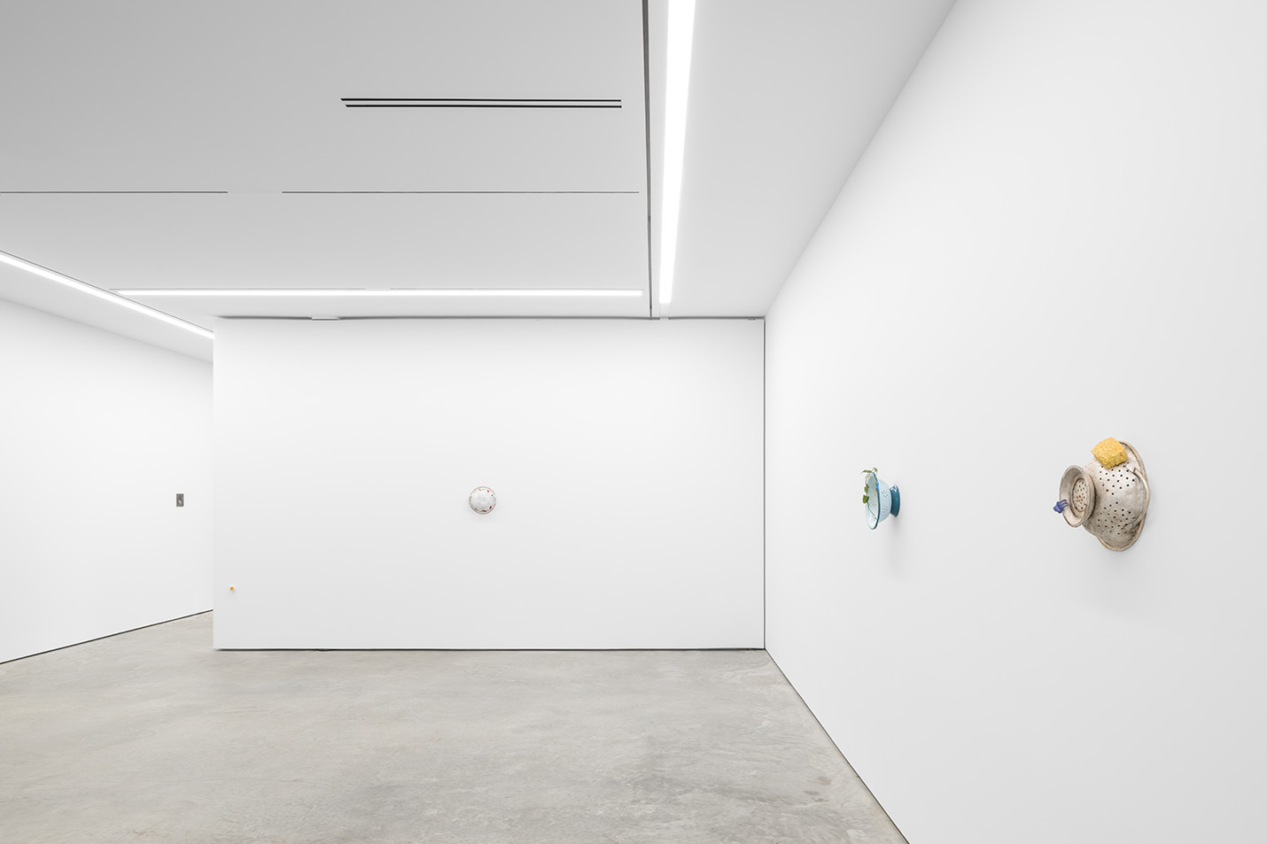 Corner of white gallery walls of Lora Reynolds Gallery designed by Stonefox Architecture