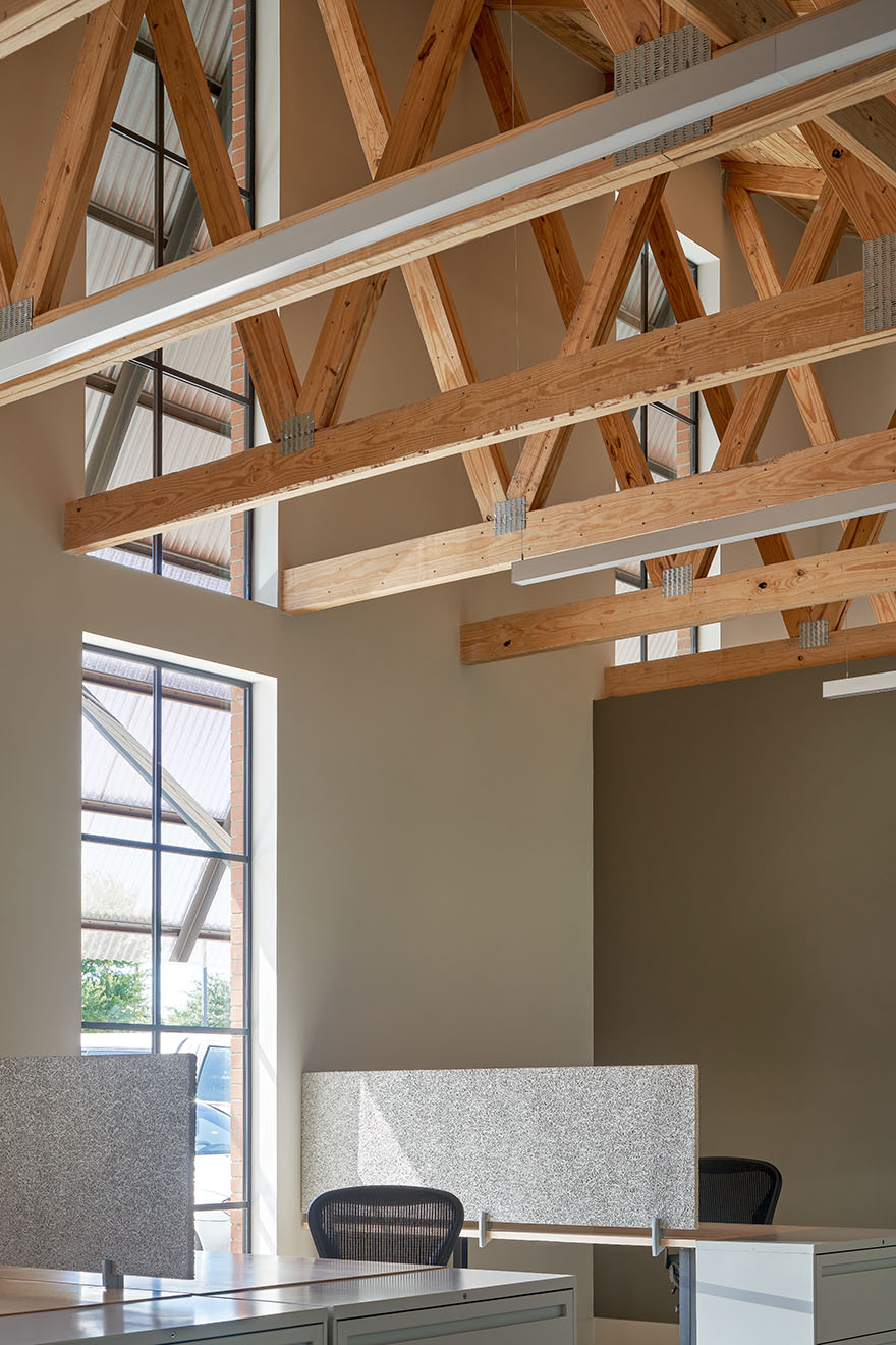 Interior detail of wooden trusses of Texas Construction Company office new construction by Chioco design architecture