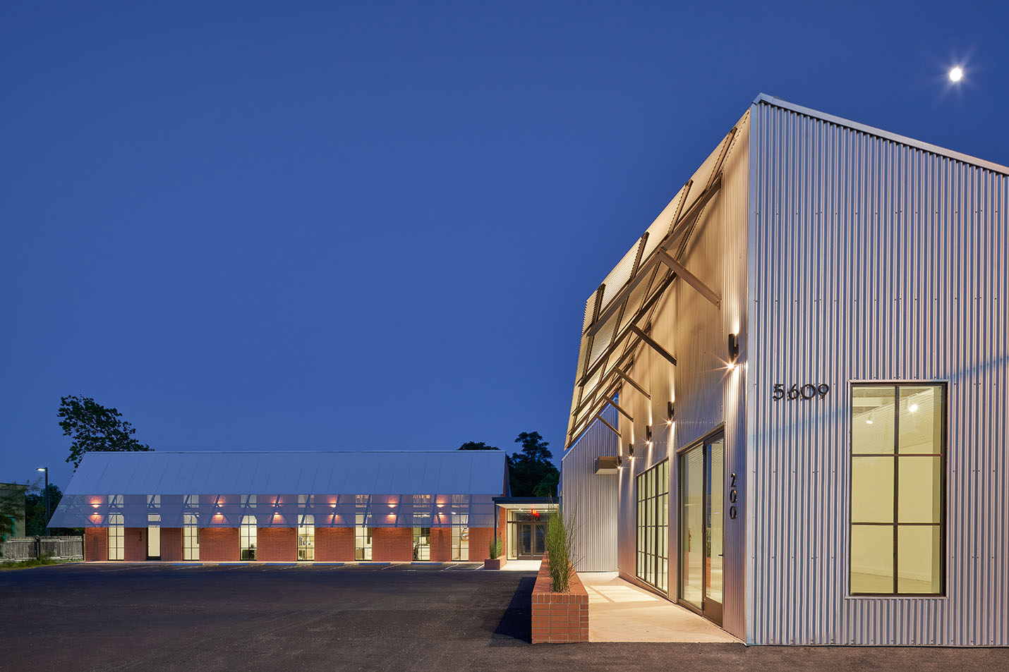 Exterior lit up at night of Texas Construction Company office new construction by Chioco design architecture