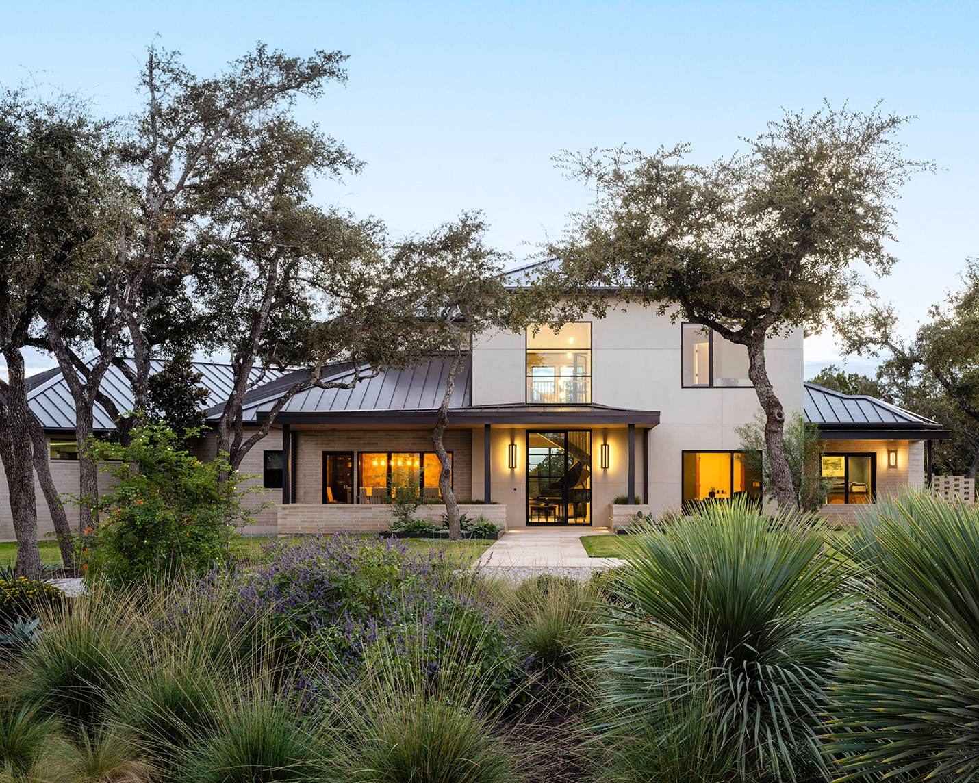 House Renovation & Addition in Austin, TX - Front exterior of house with lush lanscaping.