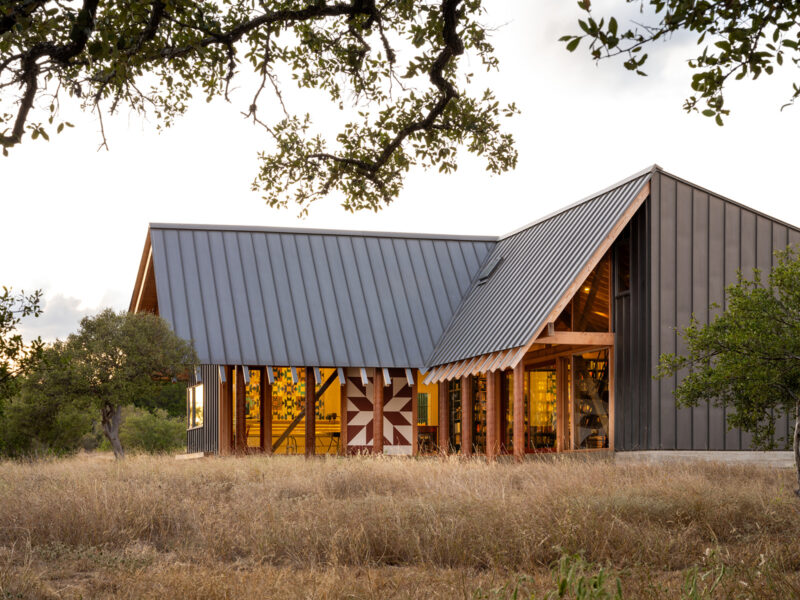 Architect-designed modern custom home with metal roof and wood accents built by Texas Construction Company in Austin, Texas
