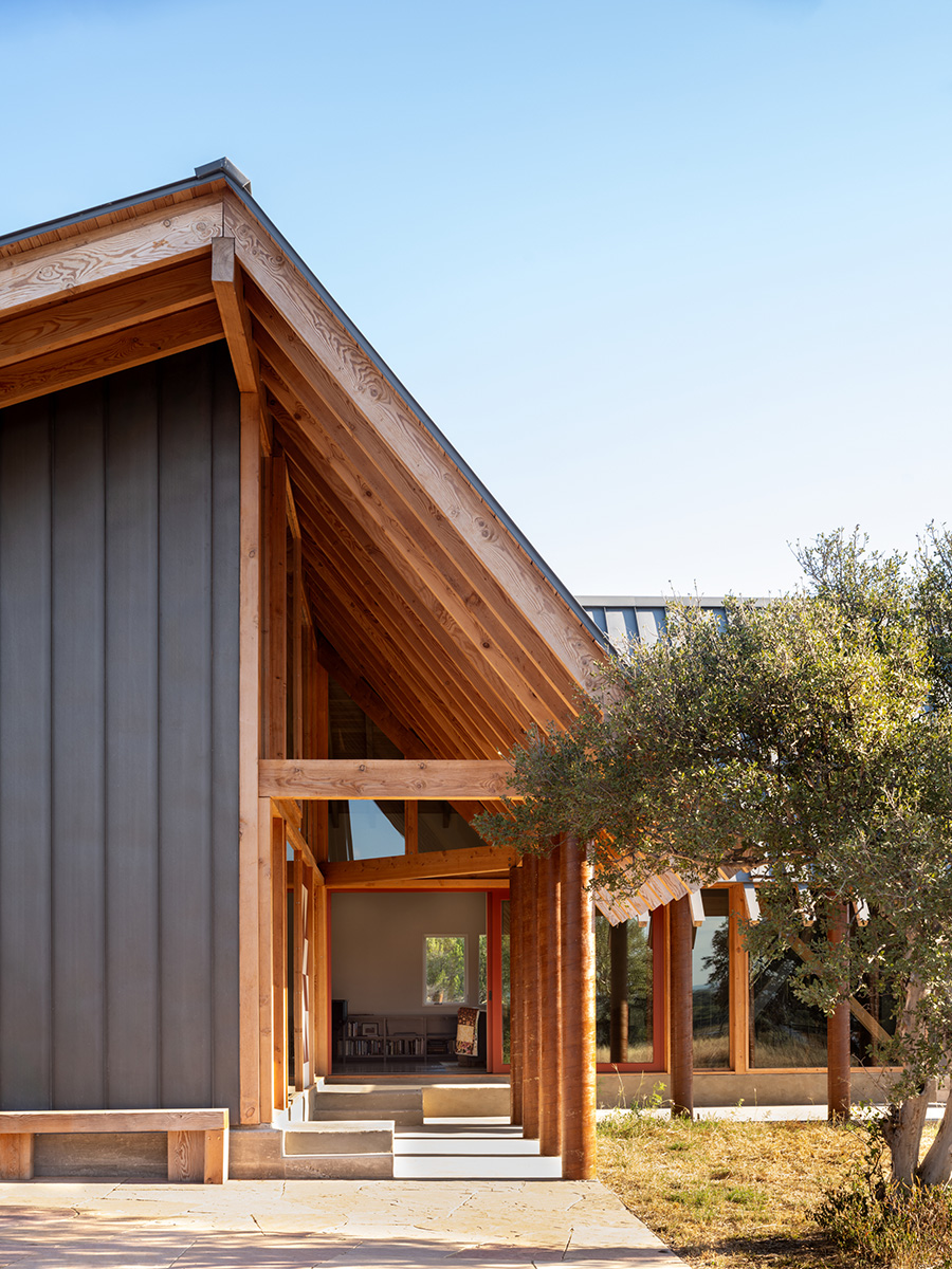 Entryway of a custom home in Austin, Texas with exposed wood beams and modern architectural design by Texas Construction Company
