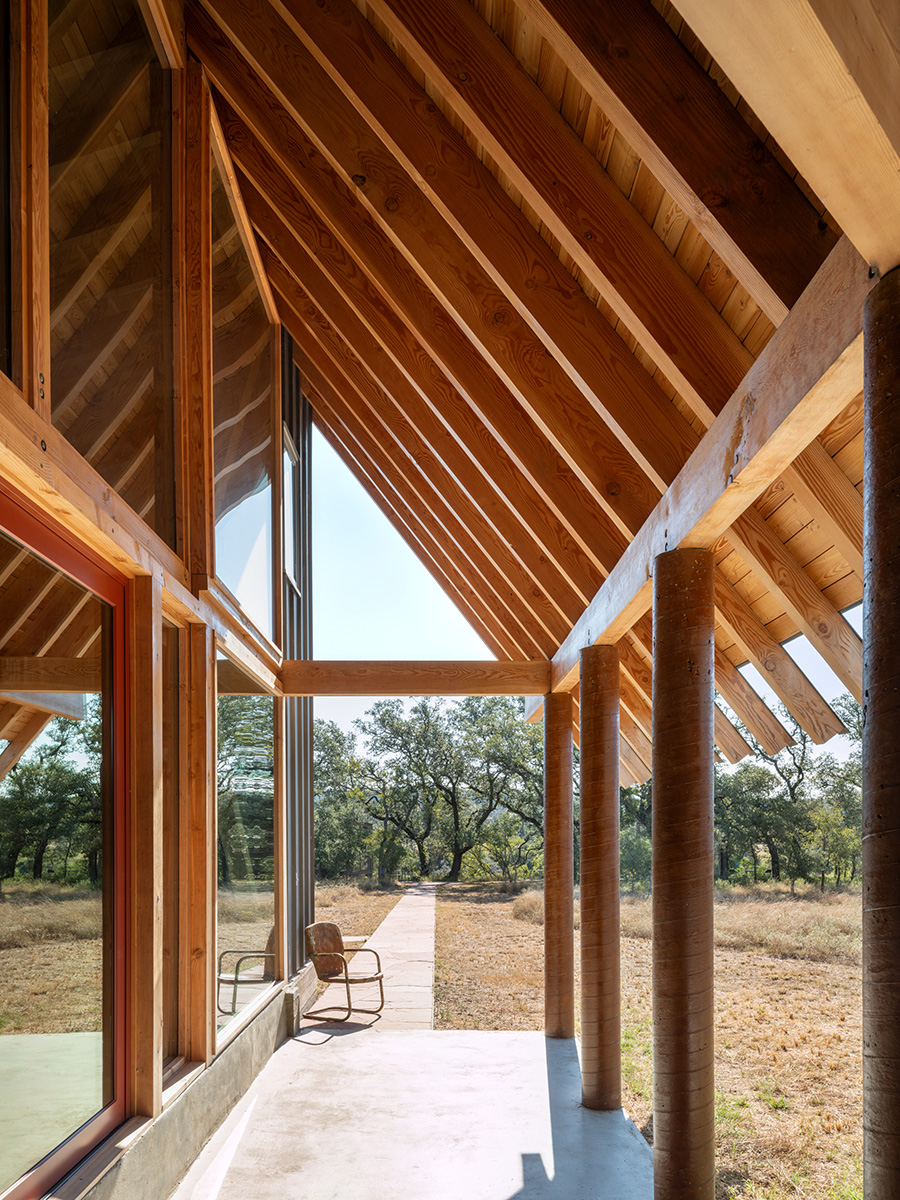 Covered outdoor walkway with exposed timber framing at a custom-built home in Austin, Texas by Texas Construction Company